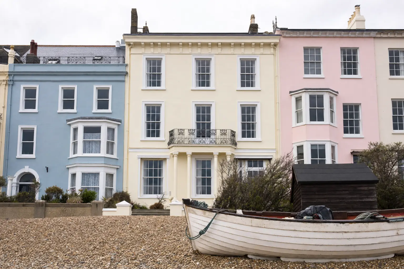 Georgian painted townhouse with a first-floor iron balcony facing Aldeburgh's shingle beach